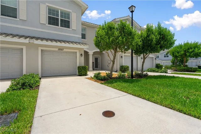 a front view of a house with a yard and garage