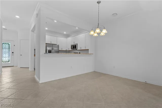 a view of a kitchen with a refrigerator a microwave and a sink
