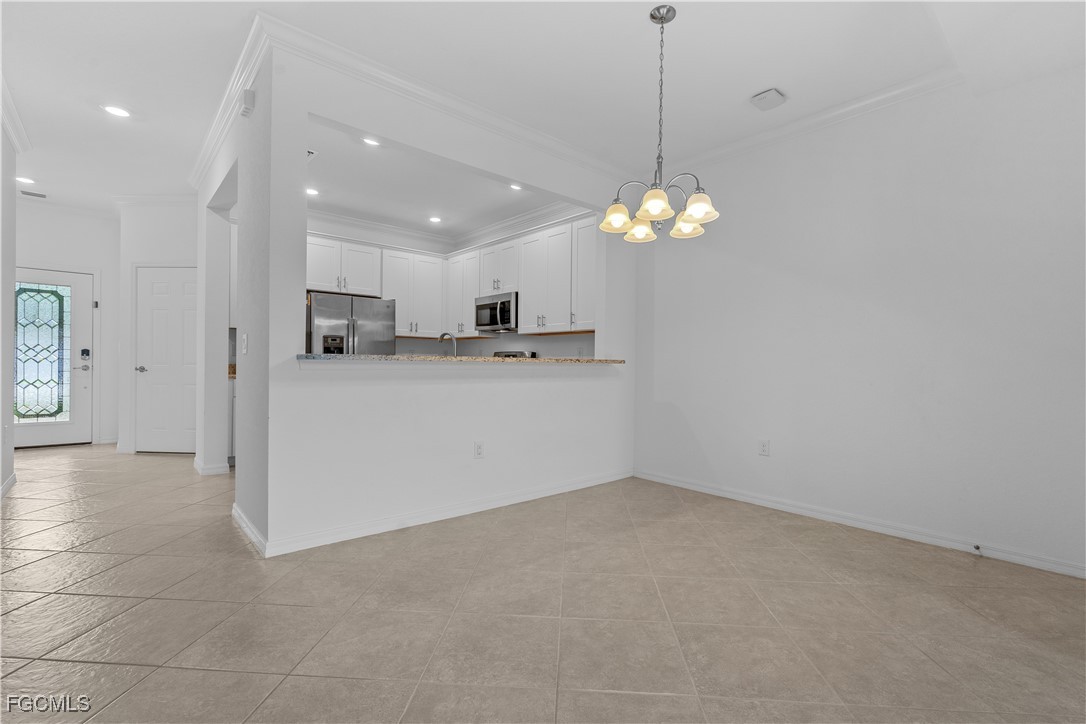 12557 Westhaven Way Fort Myers, FL 33913 - Photo 8 of 24 a view of a kitchen with a refrigerator a microwave and a sink