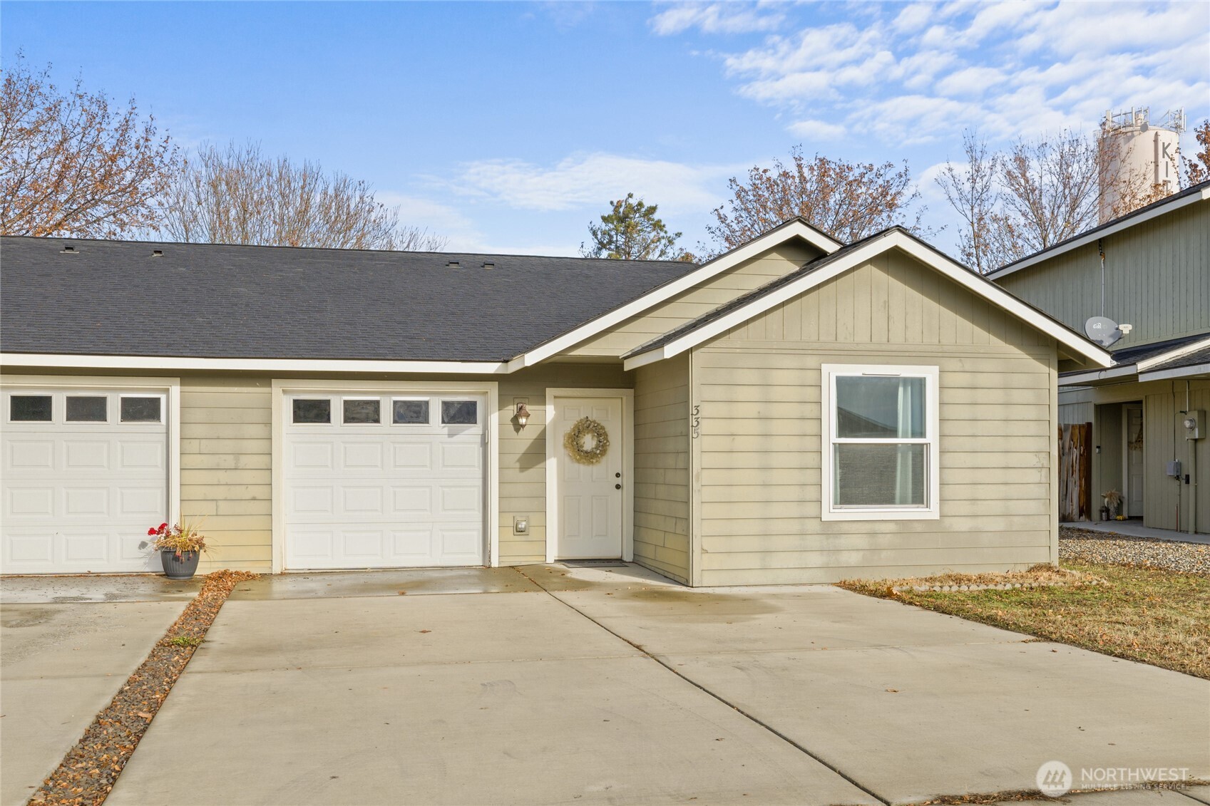 335 Pacific Loop Kittitas, WA 98934 - Photo 3 of 39 a front view of a house with a yard and garage