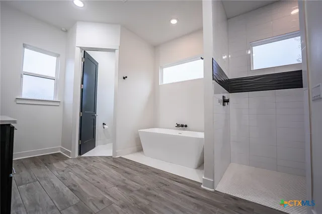 a bathroom with a bathtub and a shower