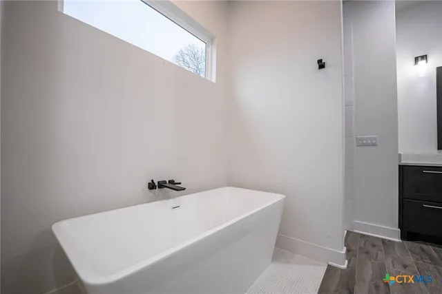 a white bath tub sitting in a bathroom
