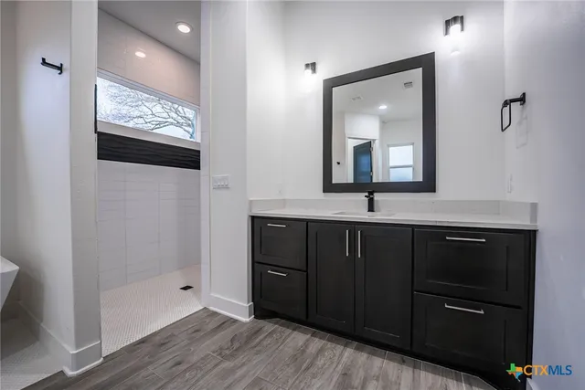 a bathroom with a double vanity sink and mirror