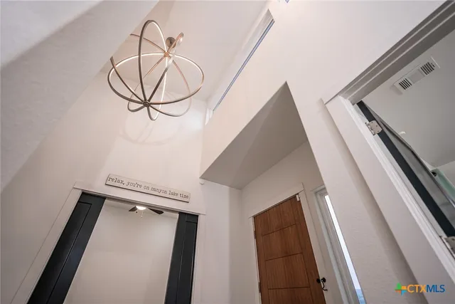 en empty room with wooden floor and ceiling fan