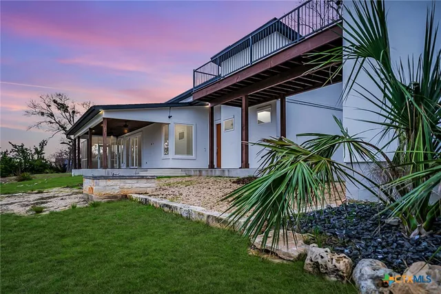 a view of house with backyard and porch