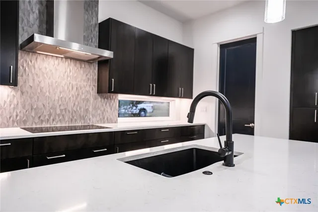 a kitchen with a sink and a refrigerator