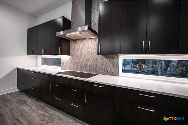 a kitchen with a sink and cabinets