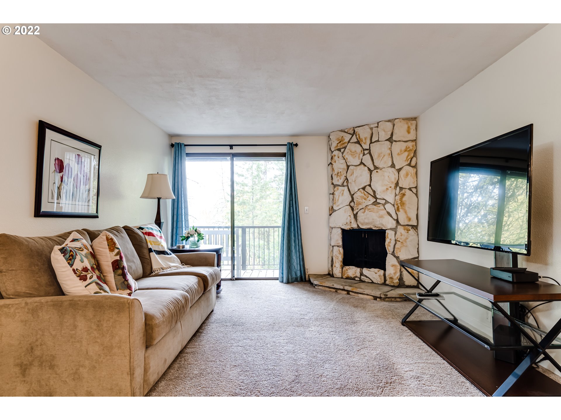 2695 Woodstone Place Eugene, OR 97405 - Photo 12 of 23 a living room with furniture a window and a flat screen tv
