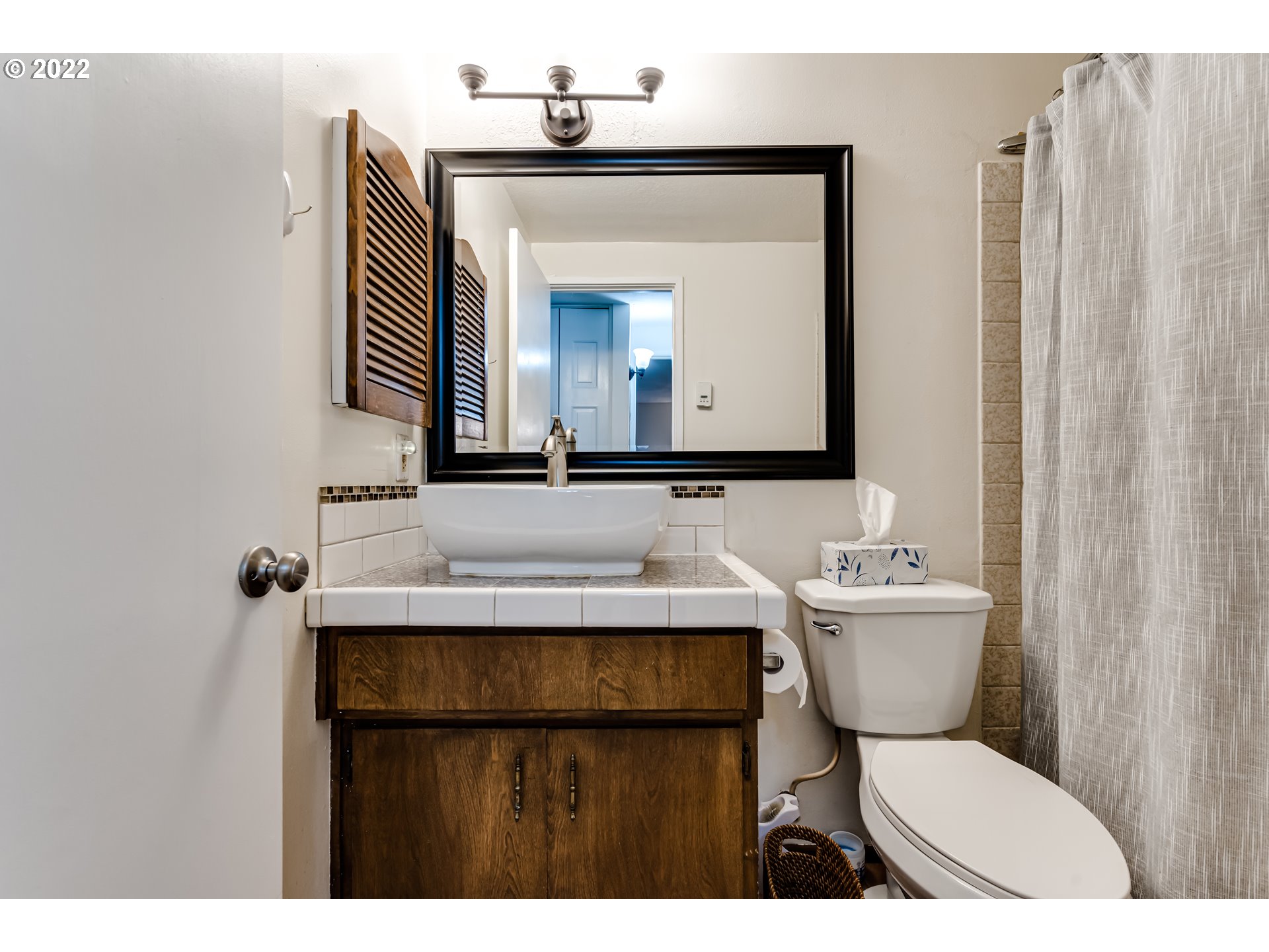 2695 Woodstone Place Eugene, OR 97405 - Photo 16 of 23 a bathroom with a toilet sink and mirror