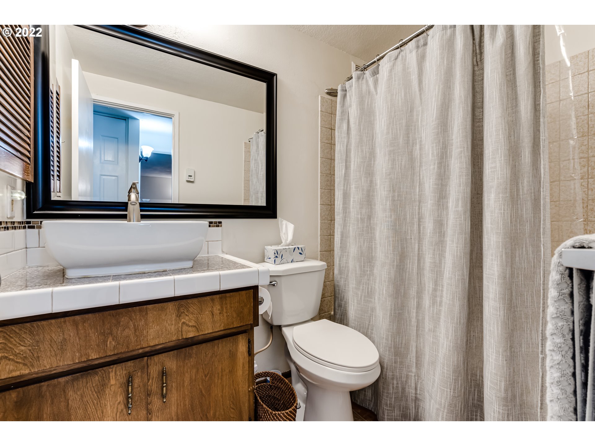 2695 Woodstone Place Eugene, OR 97405 - Photo 17 of 23 a bathroom with a sink a toilet and mirror