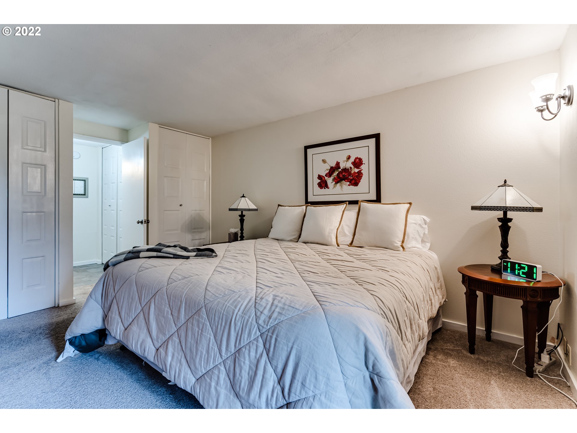 2695 Woodstone Place Eugene, OR 97405 - Photo 19 of 23 a bedroom with a bed and a painting on the wall