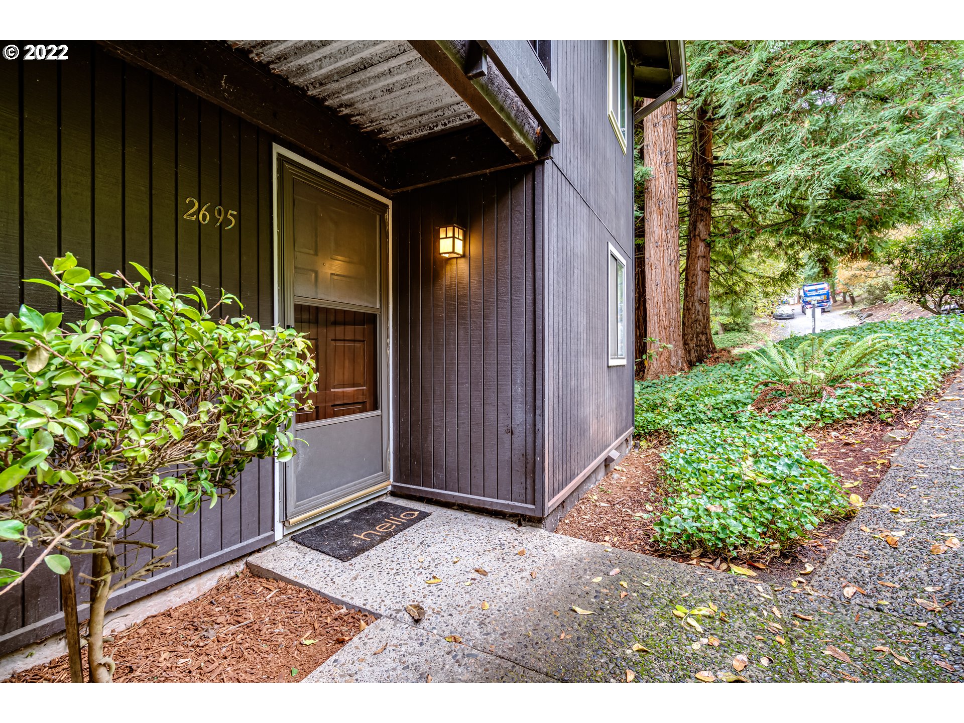2695 Woodstone Place Eugene, OR 97405 - Photo 2 of 23 a couple of potted plants in front of door