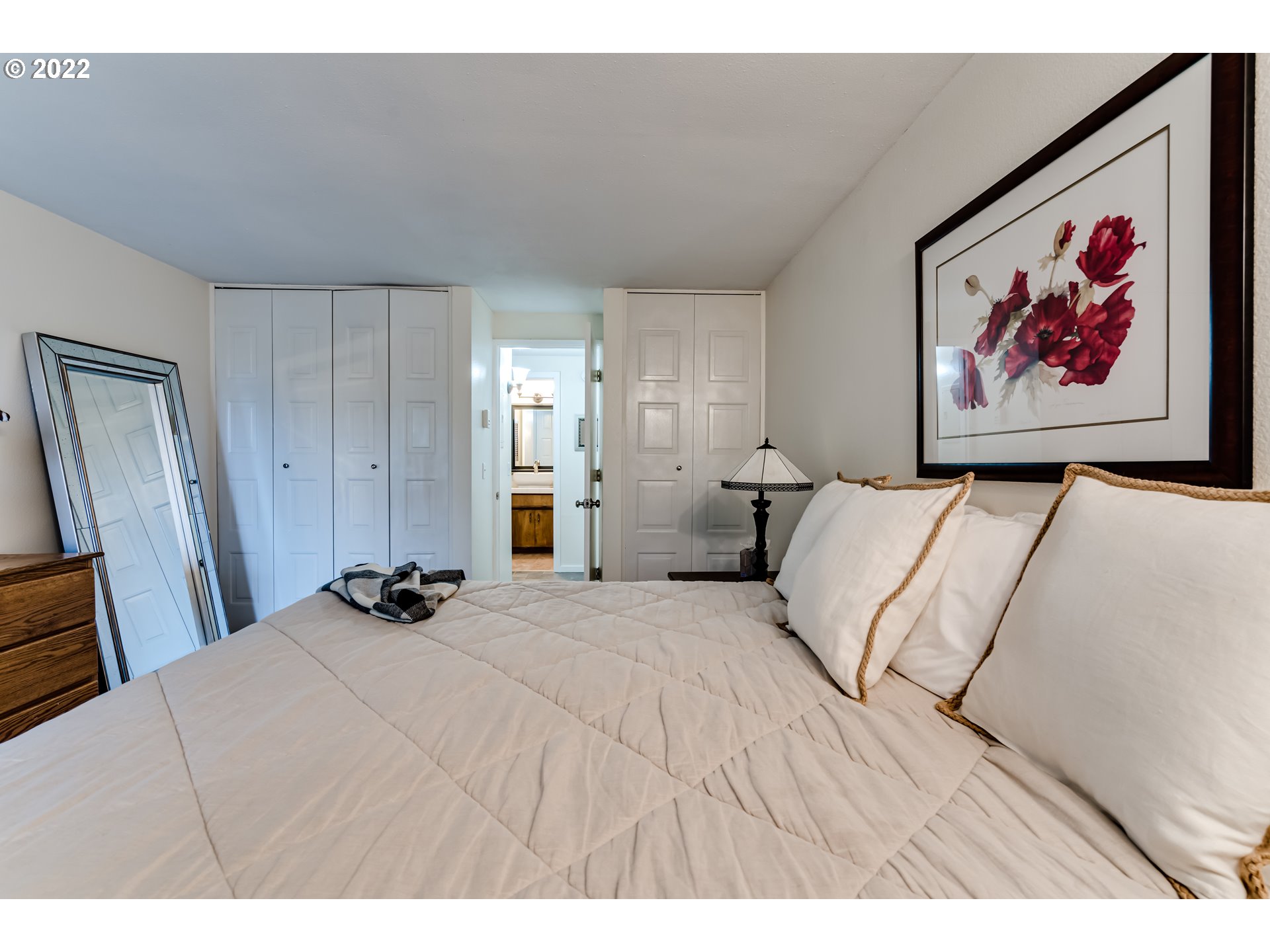 2695 Woodstone Place Eugene, OR 97405 - Photo 21 of 23 a bedroom with a bed and a painting on the wall