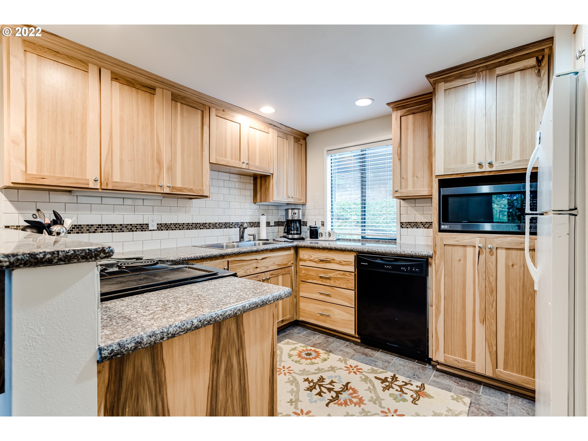 2695 Woodstone Place Eugene, OR 97405 - Photo 5 of 23 a kitchen with stainless steel appliances granite countertop a stove a sink dishwasher and a microwave oven with cabinets