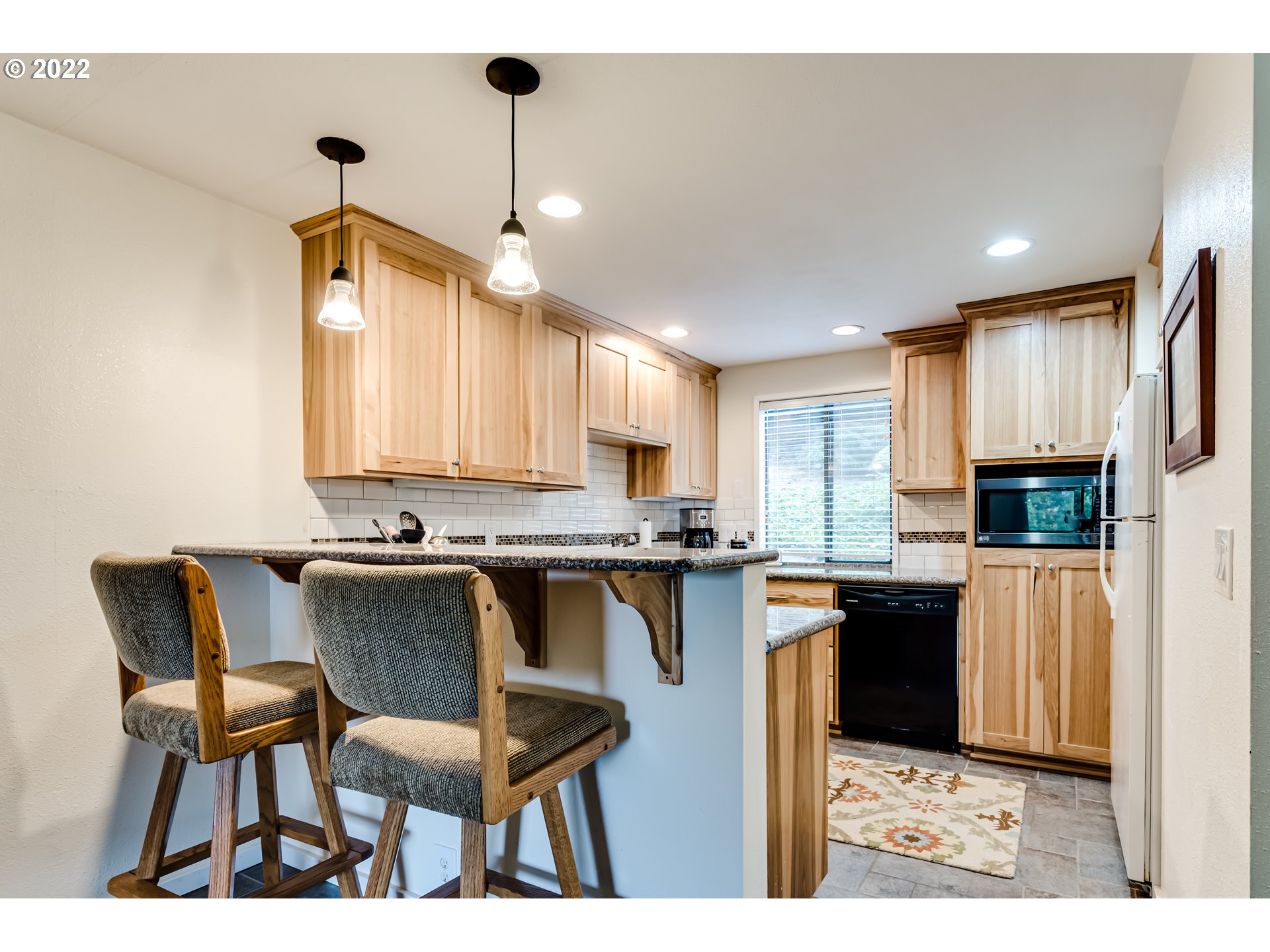2695 Woodstone Place Eugene, OR 97405 - Photo 6 of 23 a kitchen with a dining table chairs and cabinets