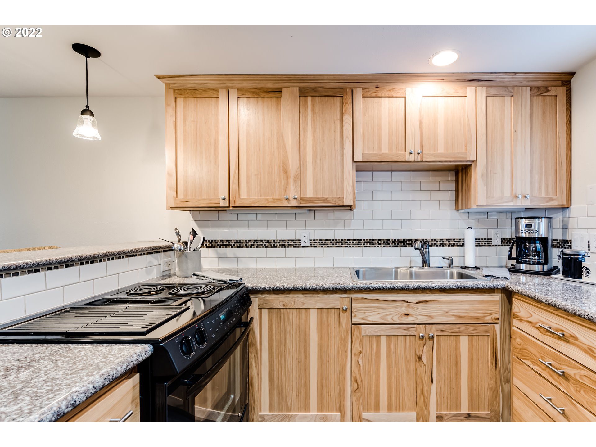 2695 Woodstone Place Eugene, OR 97405 - Photo 7 of 23 a kitchen with stainless steel appliances granite countertop a sink stove and cabinets