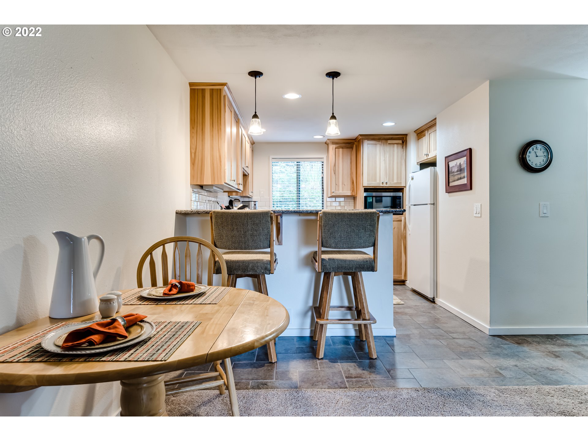 2695 Woodstone Place Eugene, OR 97405 - Photo 9 of 23 a kitchen with kitchen island a dining table and chairs