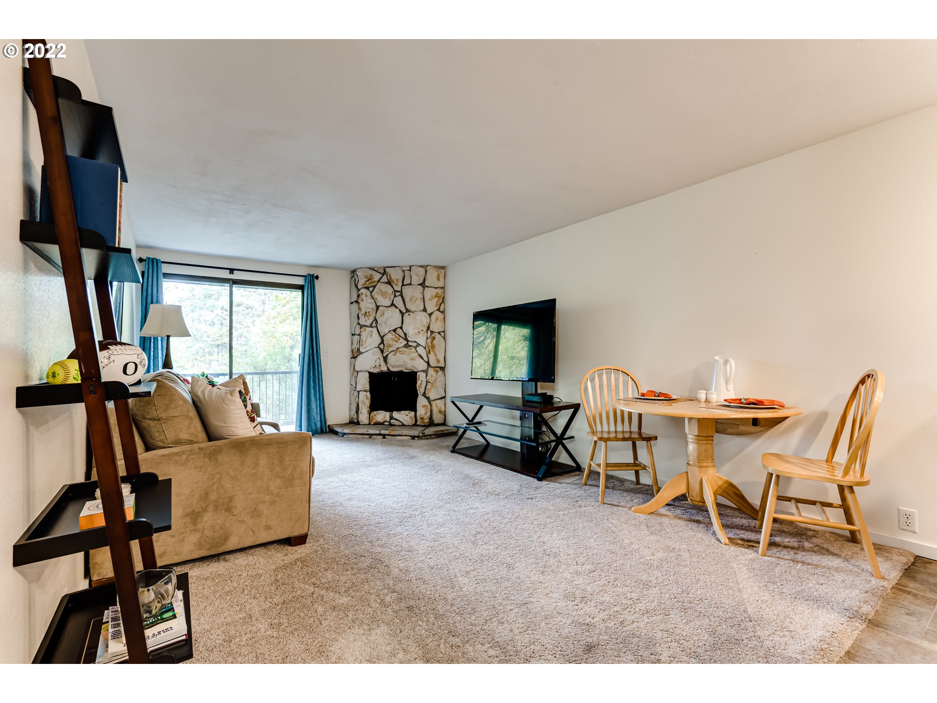 2695 Woodstone Place Eugene, OR 97405 - Photo 10 of 23 a living room with furniture and a flat screen tv