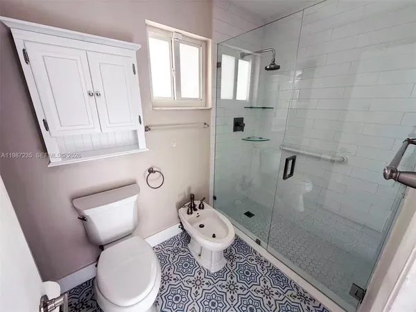 a white toilet sitting next to a bathroom sink