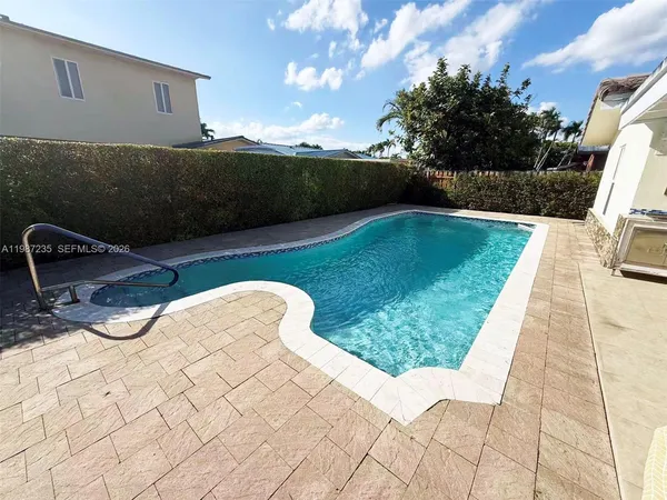 a view of a backyard with sitting area