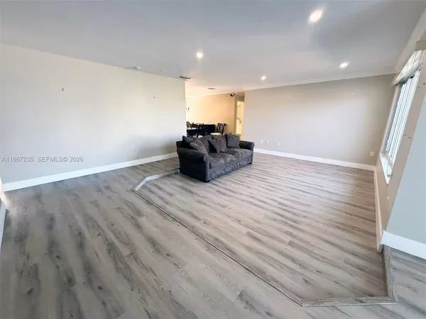 a room with wooden floor and furniture