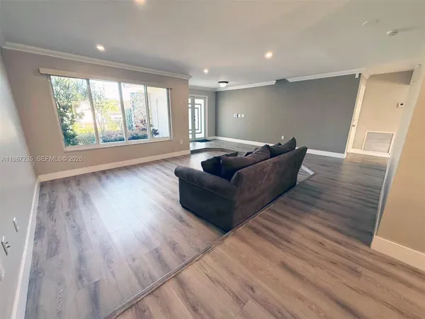 a living room with furniture and a large window
