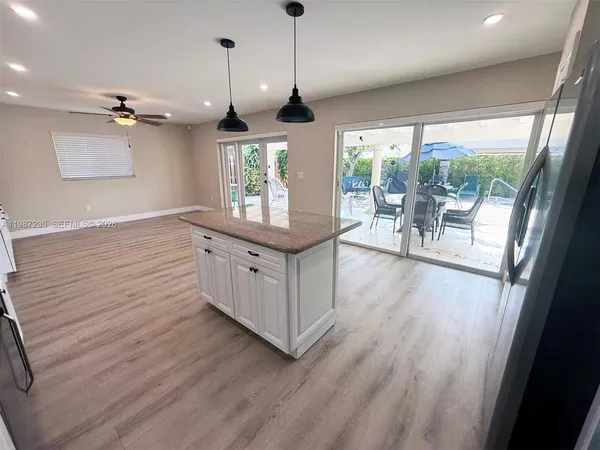 a hallway with wooden floors and white walls