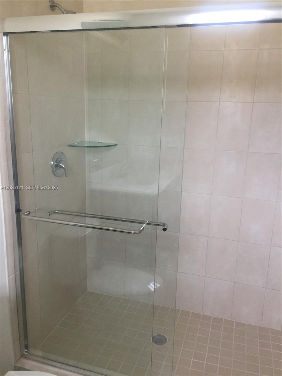 9307 West 33rd Way Hialeah, FL 33018 - Photo 11 of 23 a bathroom with a glass shower door