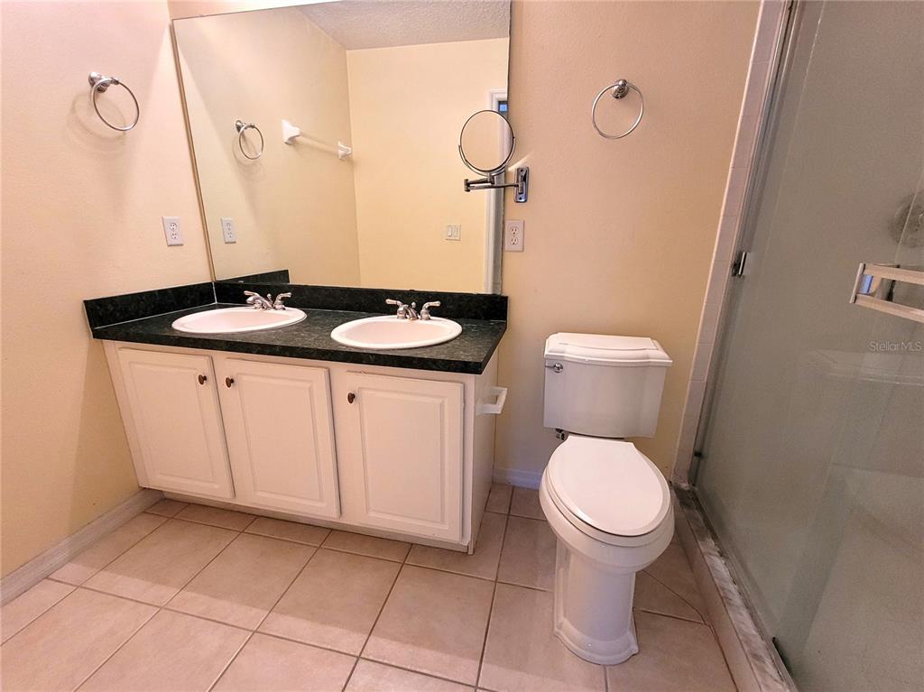 673 Sandy Neck Lane, Unit 101 Altamonte Springs, FL 32714 - Photo 17 of 39 a bathroom with a toilet a sink and mirror