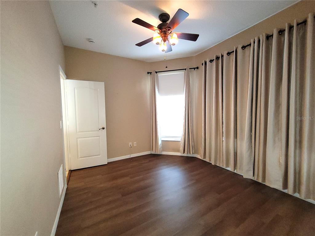 673 Sandy Neck Lane, Unit 101 Altamonte Springs, FL 32714 - Photo 23 of 39 a view of room with hardwood floor and a ceiling fan