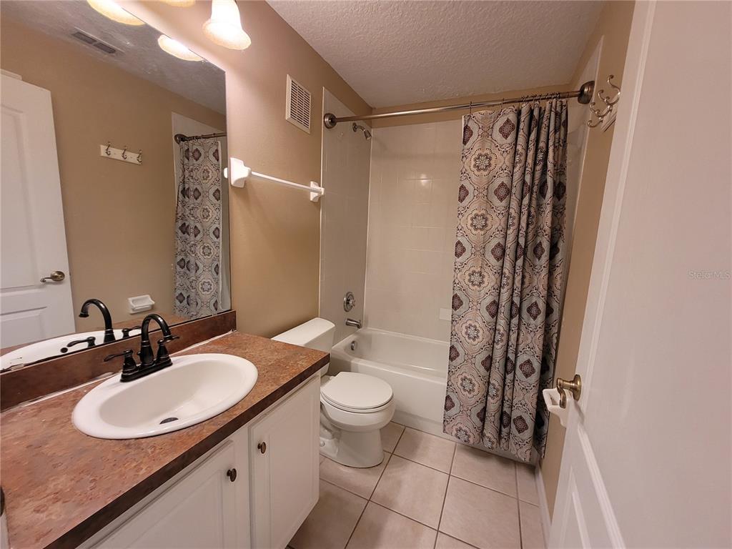 673 Sandy Neck Lane, Unit 101 Altamonte Springs, FL 32714 - Photo 24 of 39 a bathroom with a sink toilet and shower