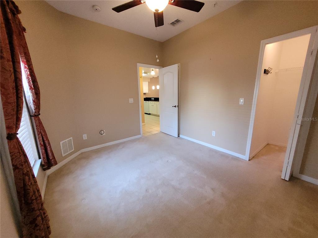 673 Sandy Neck Lane, Unit 101 Altamonte Springs, FL 32714 - Photo 26 of 39 an empty room with chandelier fan and windows