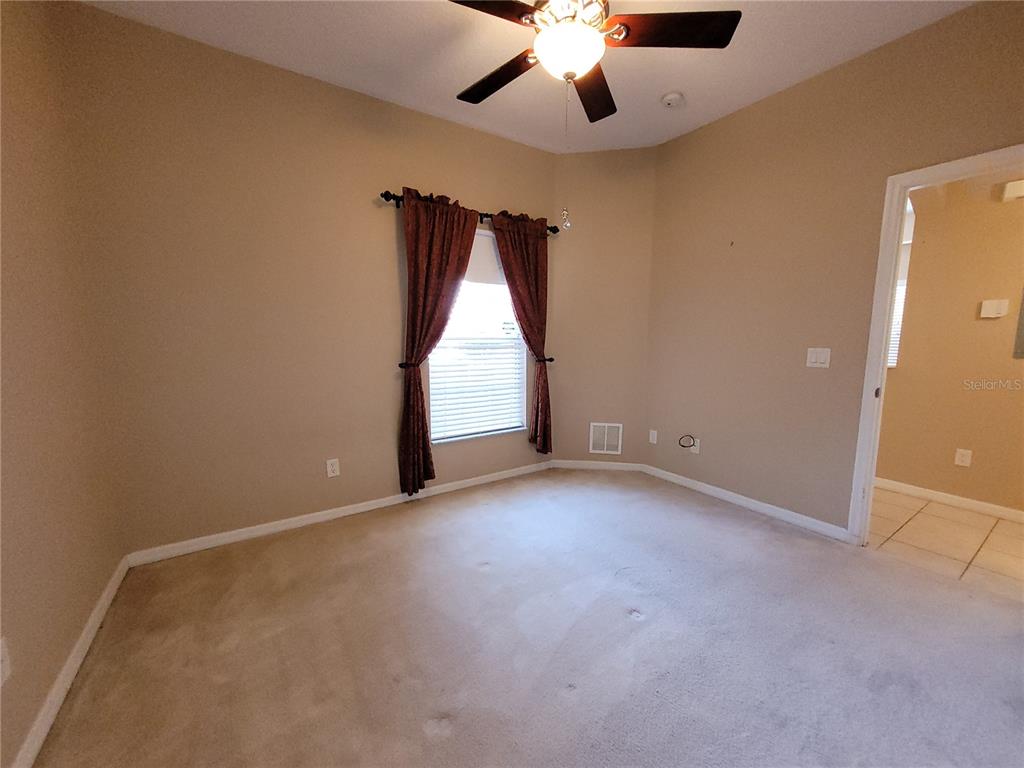 673 Sandy Neck Lane, Unit 101 Altamonte Springs, FL 32714 - Photo 27 of 39 an empty room with a window and a ceiling fan