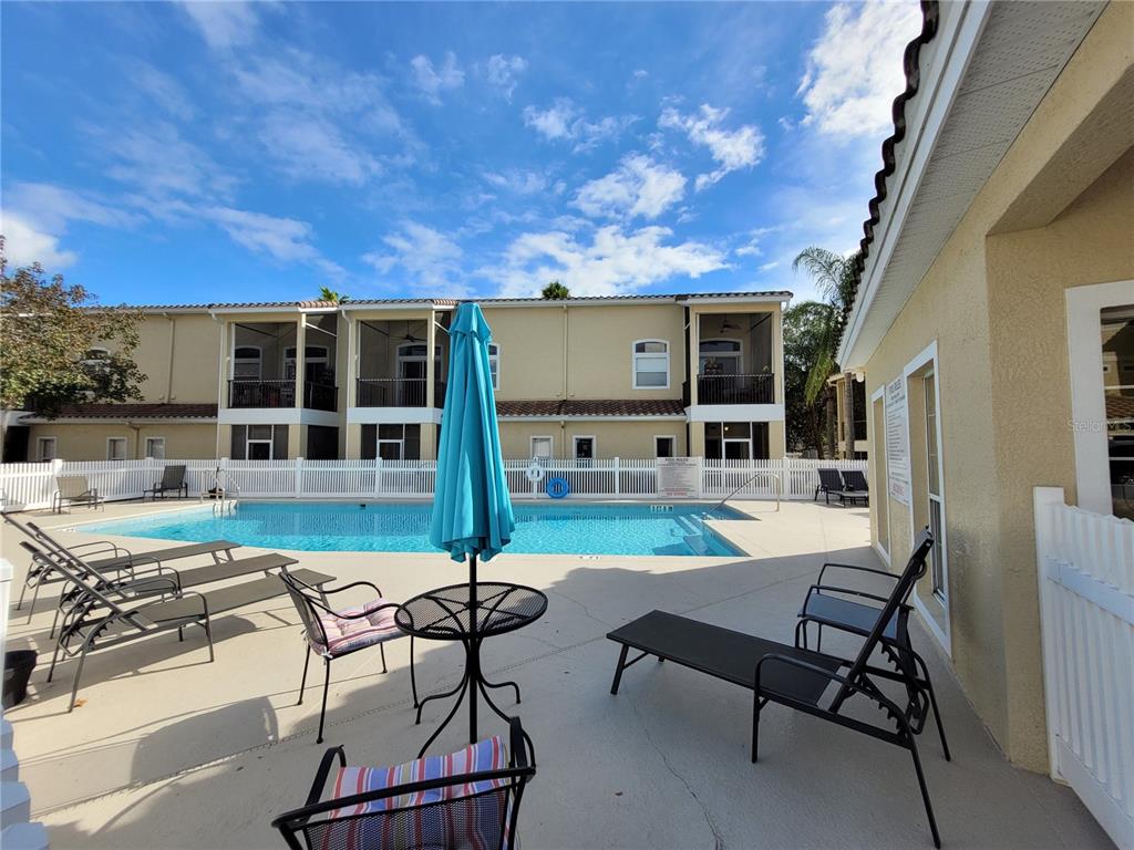 673 Sandy Neck Lane, Unit 101 Altamonte Springs, FL 32714 - Photo 38 of 39 a view of a patio with table and chairs with wooden floor and fence