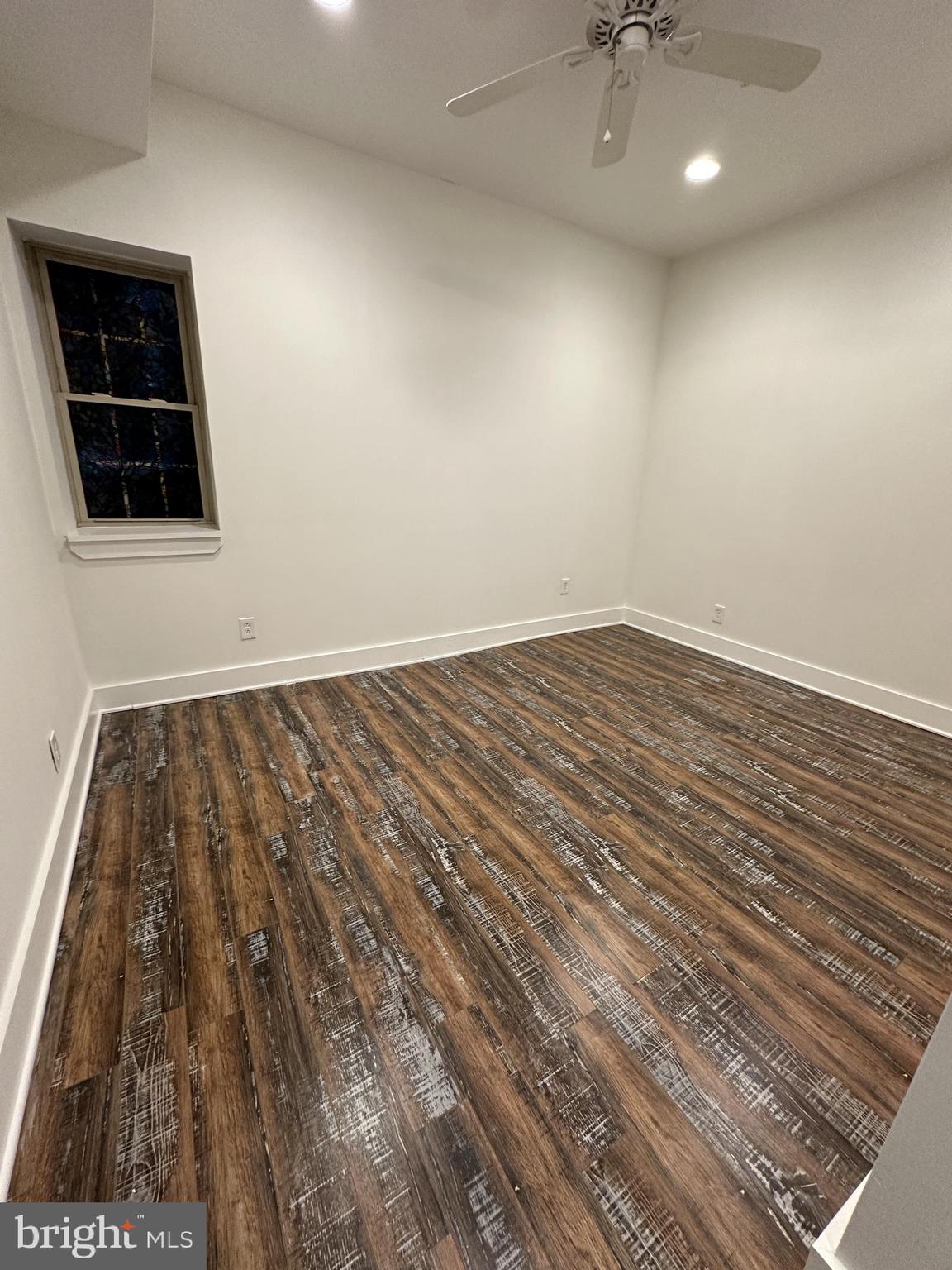 2206 North Front Street, Unit 2B Philadelphia, PA 19133 - Photo 13 of 28 an empty room with wooden floor and windows