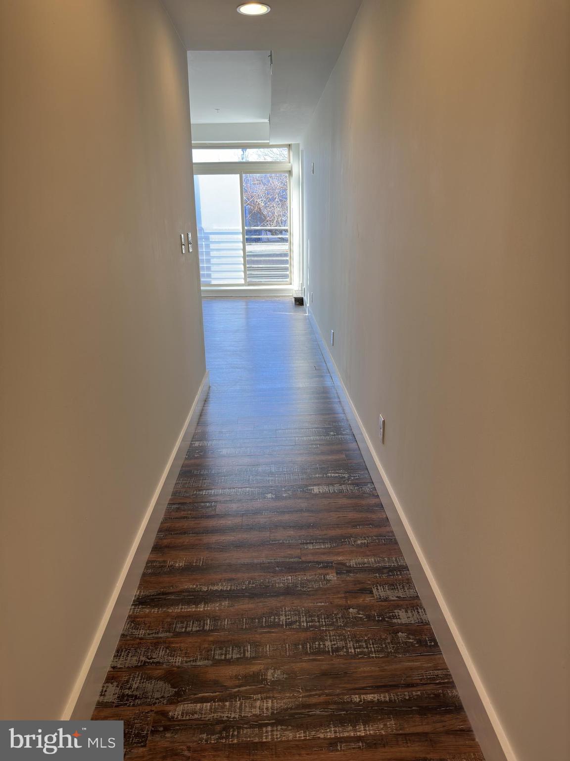 2206 North Front Street, Unit 2B Philadelphia, PA 19133 - Photo 14 of 28 a view of a hallway with wooden floor and staircase