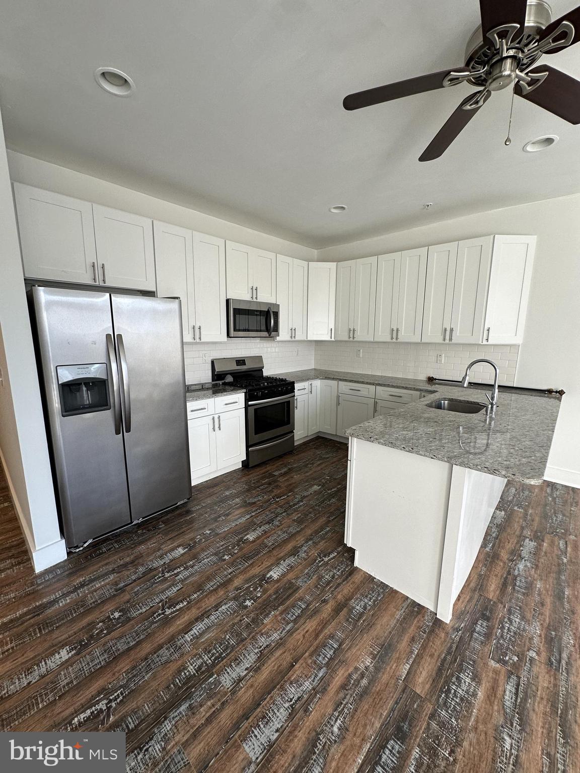 2206 North Front Street, Unit 2B Philadelphia, PA 19133 - Photo 18 of 28 a kitchen with stainless steel appliances granite countertop a refrigerator a stove and a sink