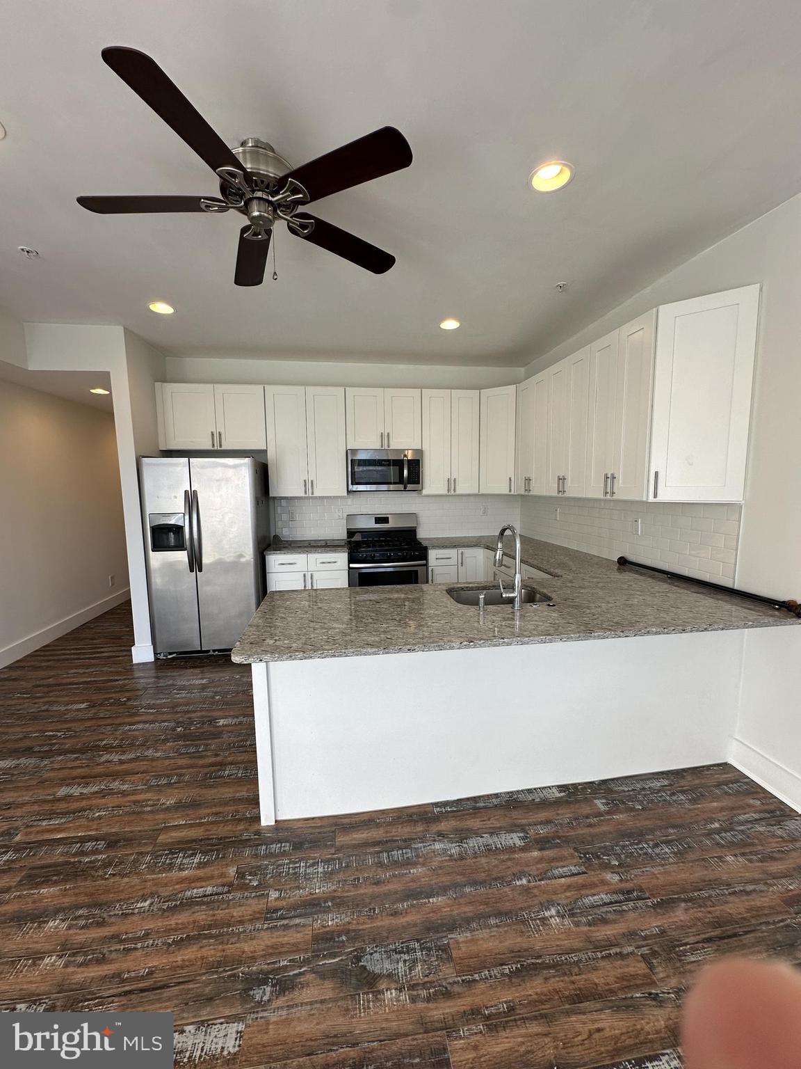 2206 North Front Street, Unit 2B Philadelphia, PA 19133 - Photo 20 of 28 a kitchen with stainless steel appliances granite countertop a sink a stove top oven a counter space and cabinets