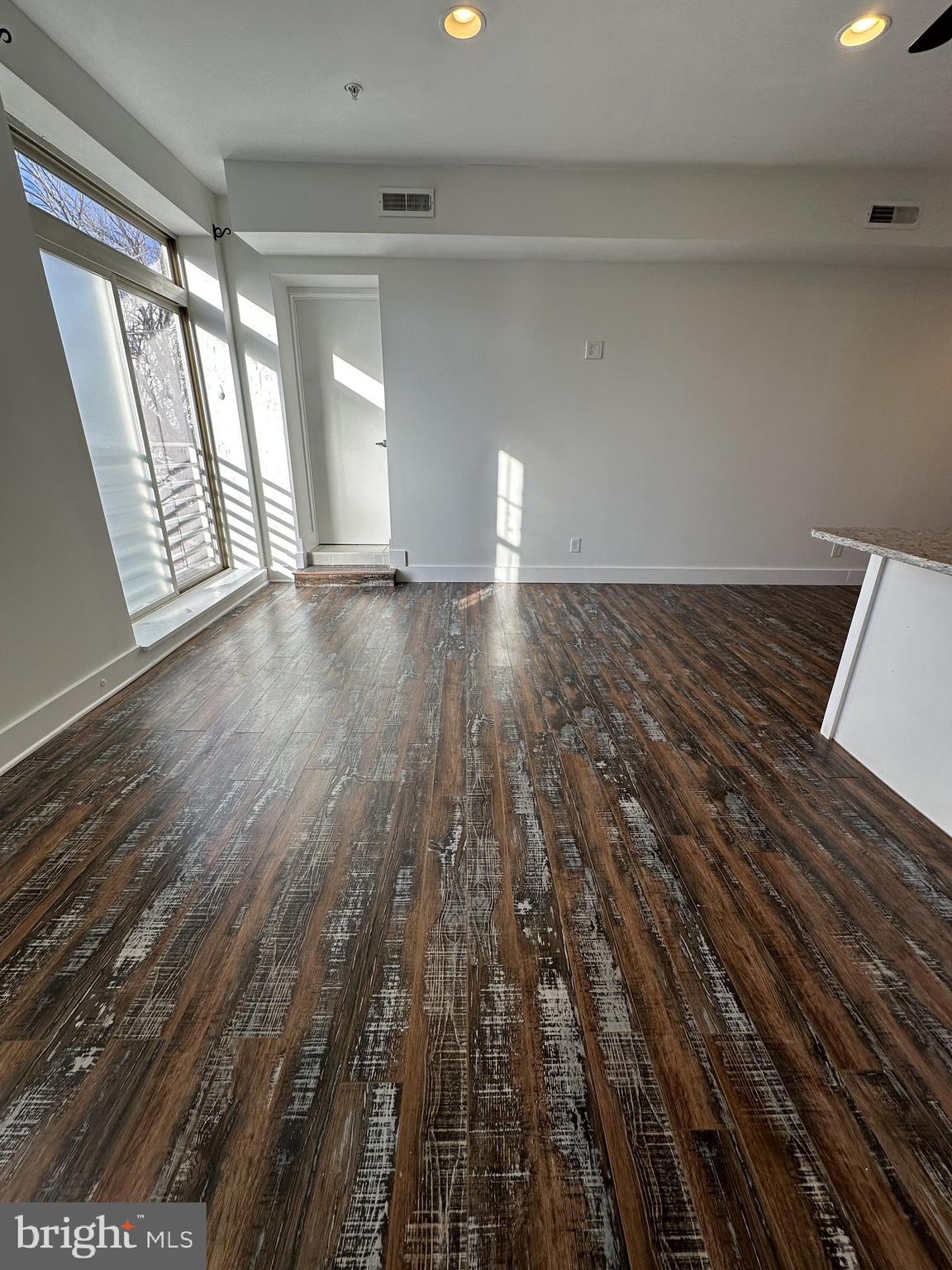 2206 North Front Street, Unit 2B Philadelphia, PA 19133 - Photo 23 of 28 wooden floor in an empty room with a window