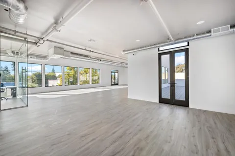 a living room with hardwood floor and a ceiling fan