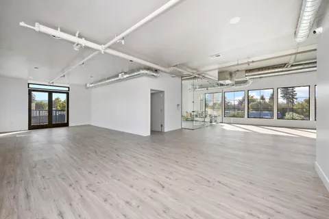 a living room with furniture and a floor to ceiling window