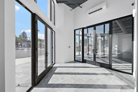 a view of an empty room with wooden floor