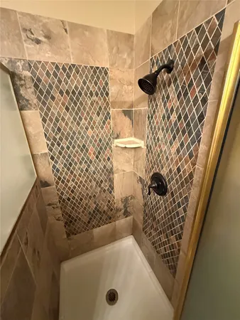 a bathroom with a bathtub and shower