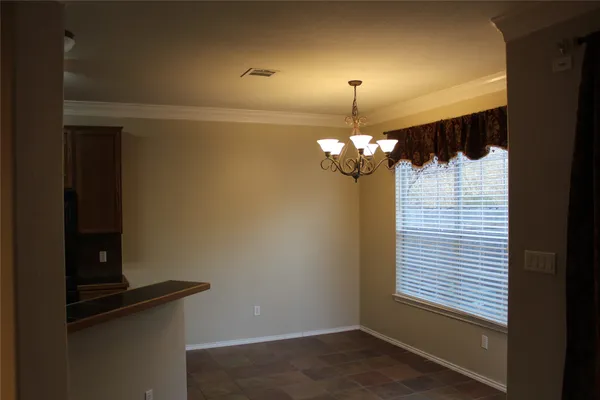 a view of a chandelier fan and wooden floor