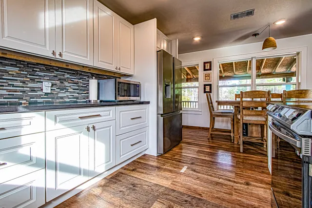 a kitchen with stainless steel appliances granite countertop a stove and cabinets