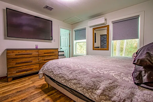 a bedroom with a bed and a window