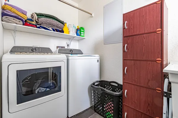 a bathroom with a granite countertop toilet sink and mirror