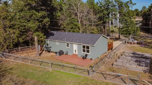 a view of a house with a door and wooden fence