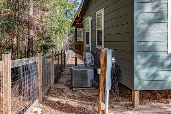 a backyard of a house with barbeque oven table and chairs