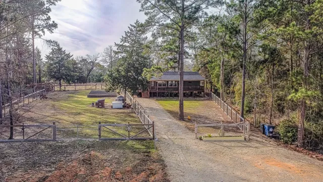 a view of a swimming pool with a patio and a yard